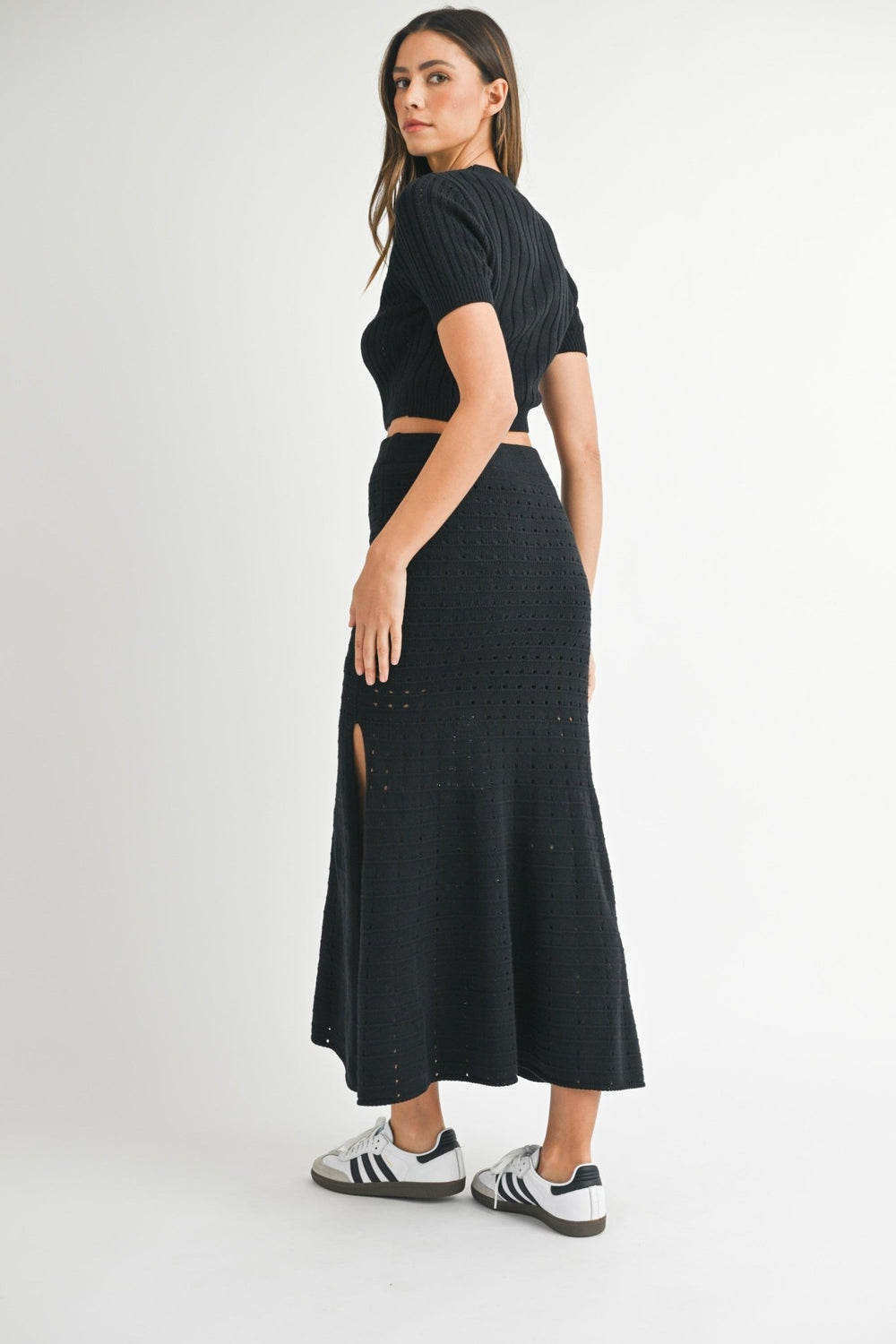 Matching black knit crop top and maxi skirt styled as one outfit