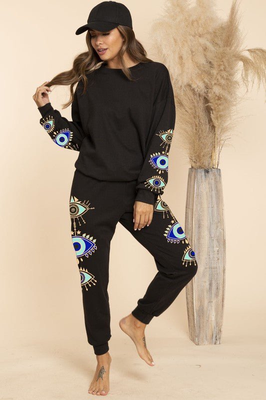 Blue and black evil eye sweater styled as part of a lounge set