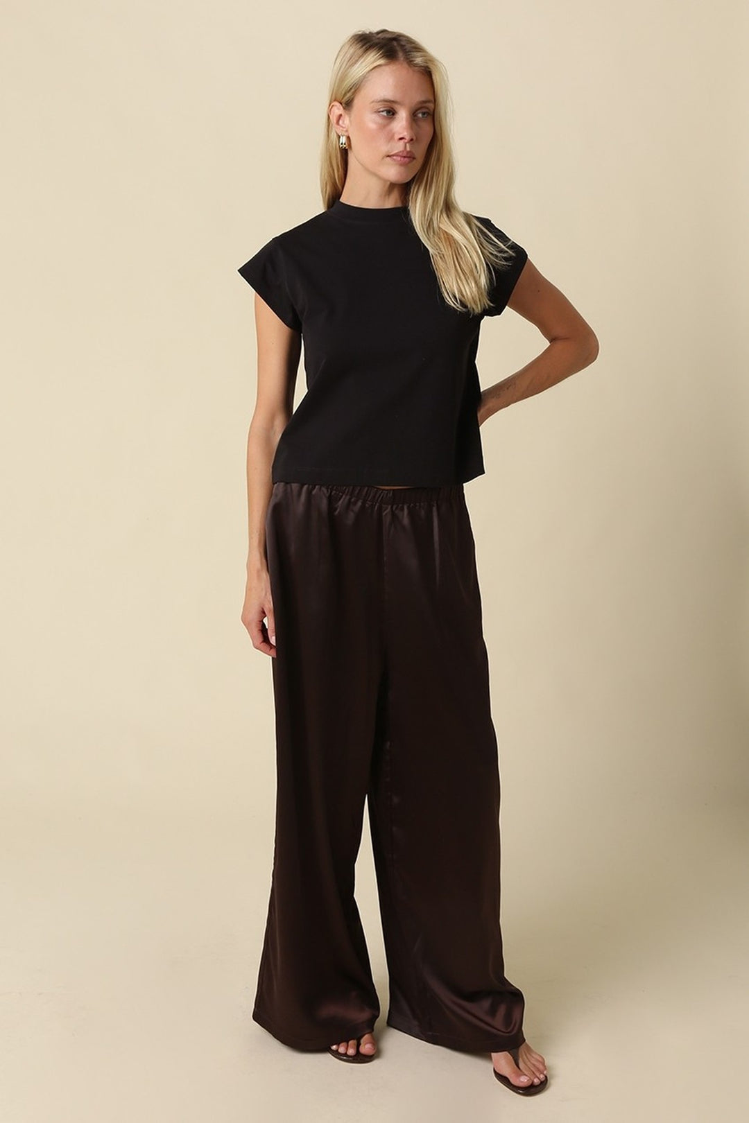 Black mock neck crop tee worn with trousers, full length