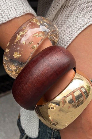 Bold wide gold-plated resin bangle bracelet with mixed textures