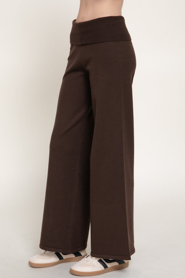 Back view of the brown wide leg knit pants with fold over waistband and sneakers