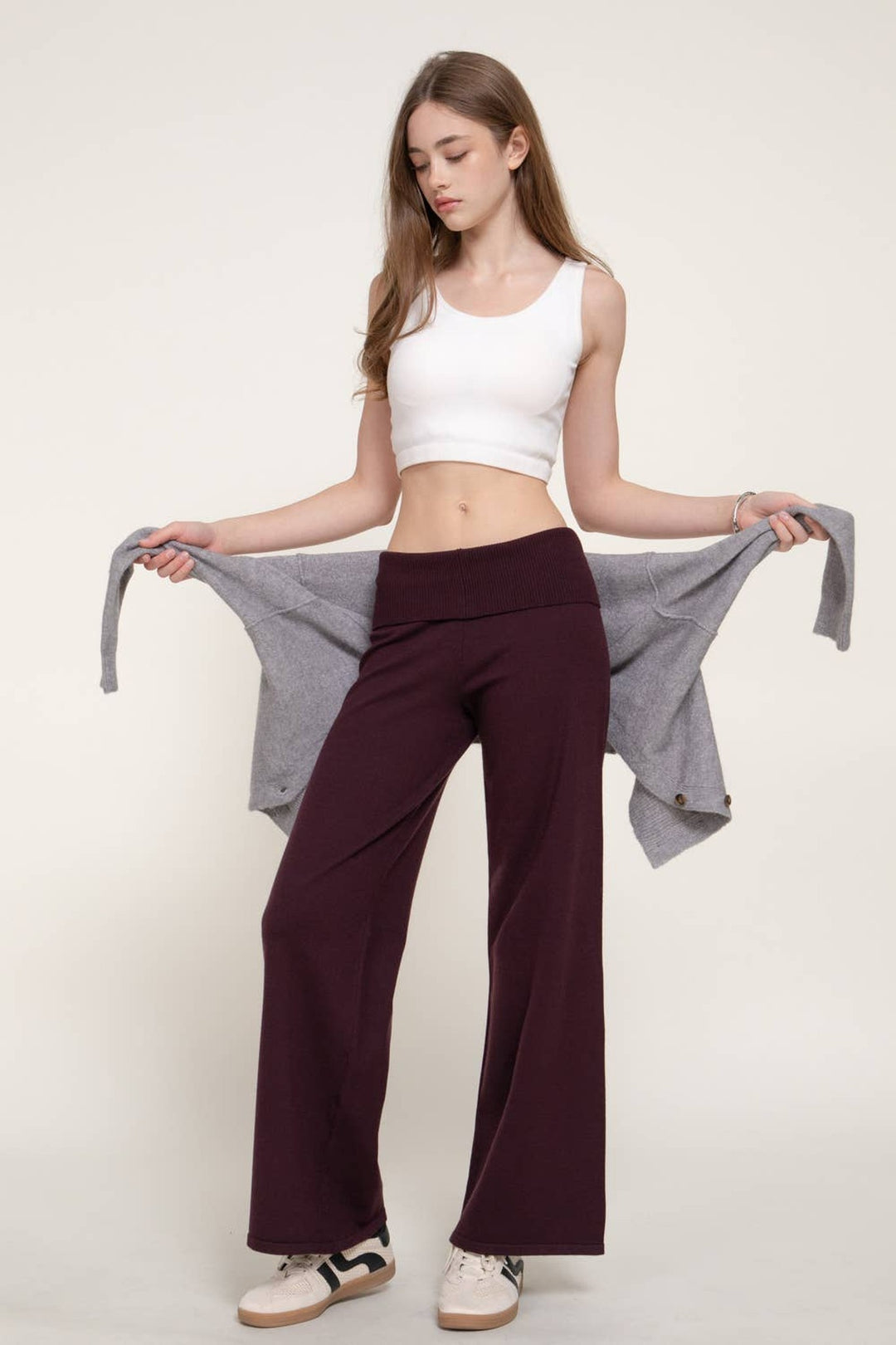 Full-length view of the Burgundy Fold Over Waist Sweater Pants with a white crop tank and grey hoodie, a fall outfit