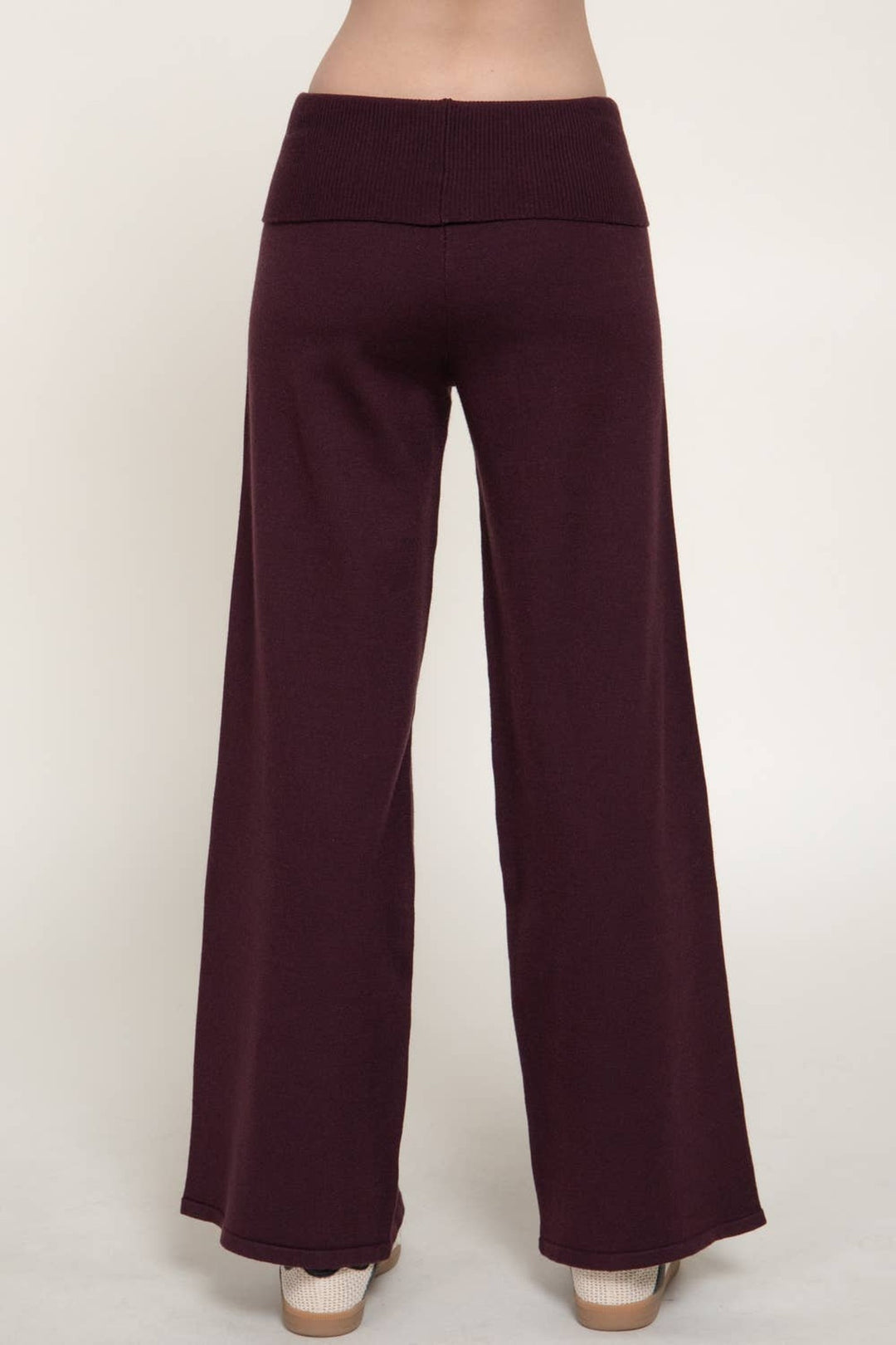 Side view of the burgundy fold over waist sweater pants showing the wide leg drape