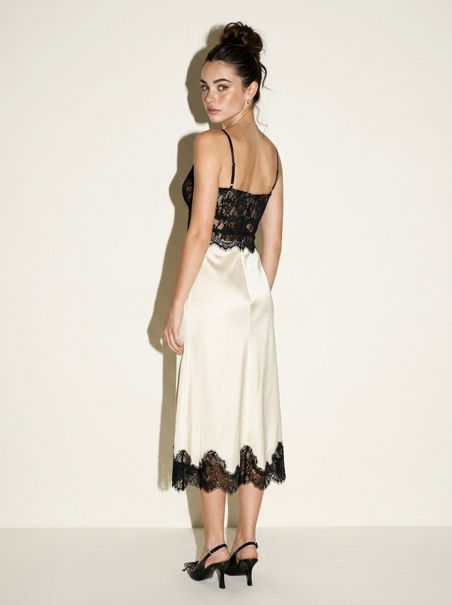 Back view of the ivory black lace midi dress showing thin cami straps and the lace bodice back