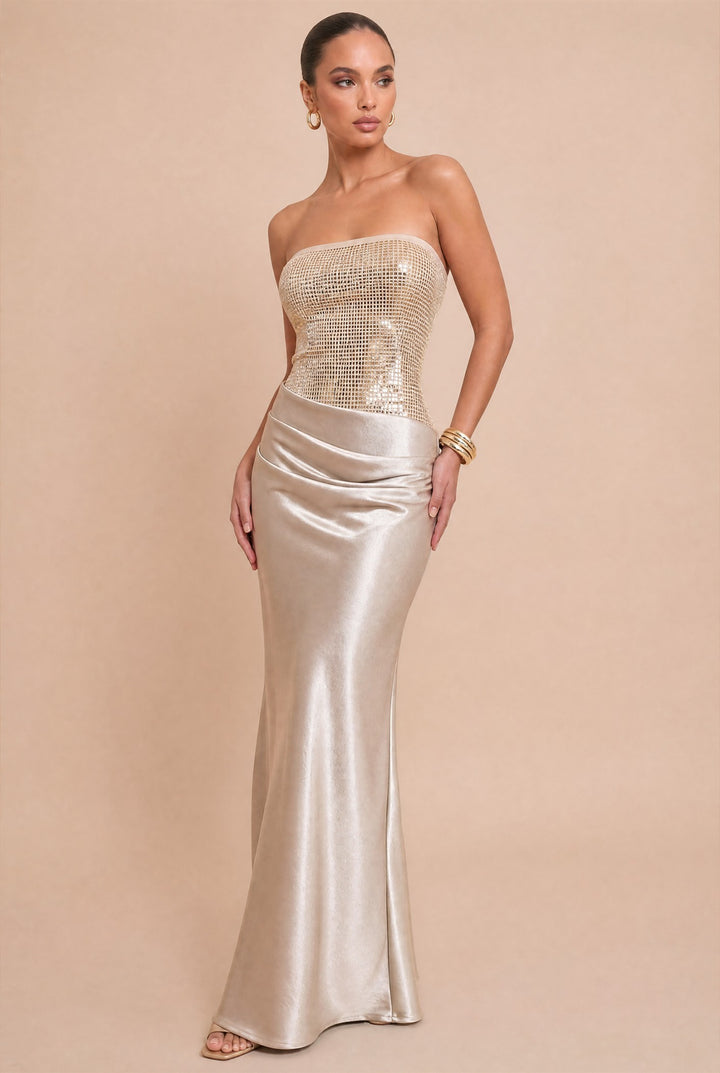 Front view of Luxxel rose champagne strapless maxi dress with a sequin bodice and draped satin skirt