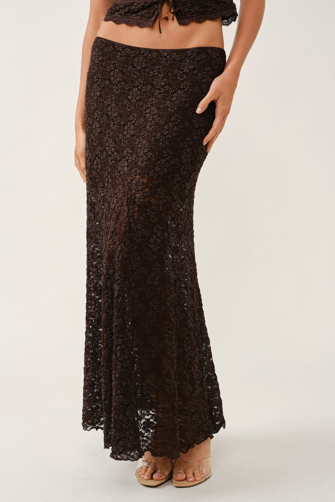 Front waist-down view of the brown lace maxi skirt with lined upper panel and sheer floral lace hem