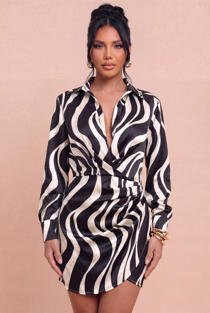 Front view of Luxxel black ivory wave-print mini shirtdress with a crossover neckline and draped skirt