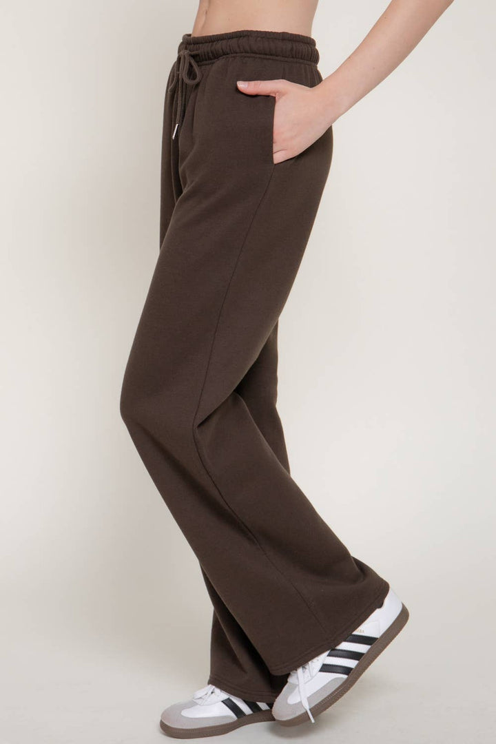 Side view of the dark brown fleece joggers with sneakers, a Thanksgiving travel outfit