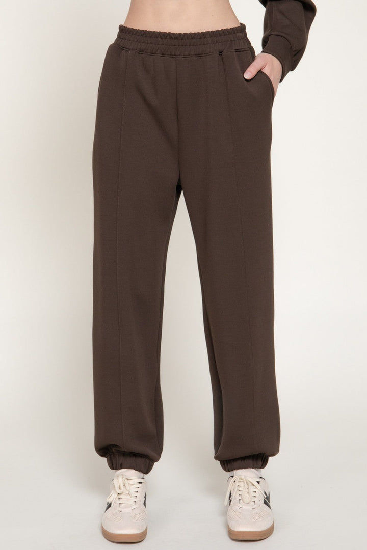 Dark brown scuba jogger pants with side pockets, front view