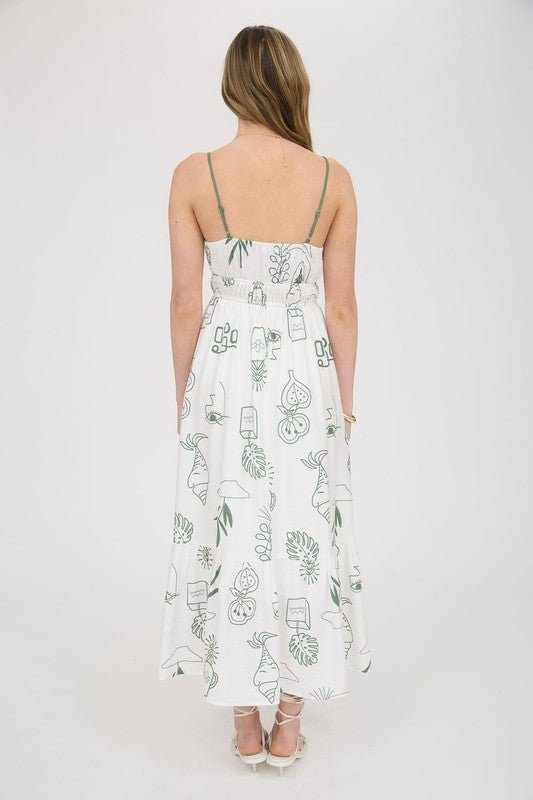 Flowy tiered skirt and adjustable spaghetti straps on a white and sage green midi dress