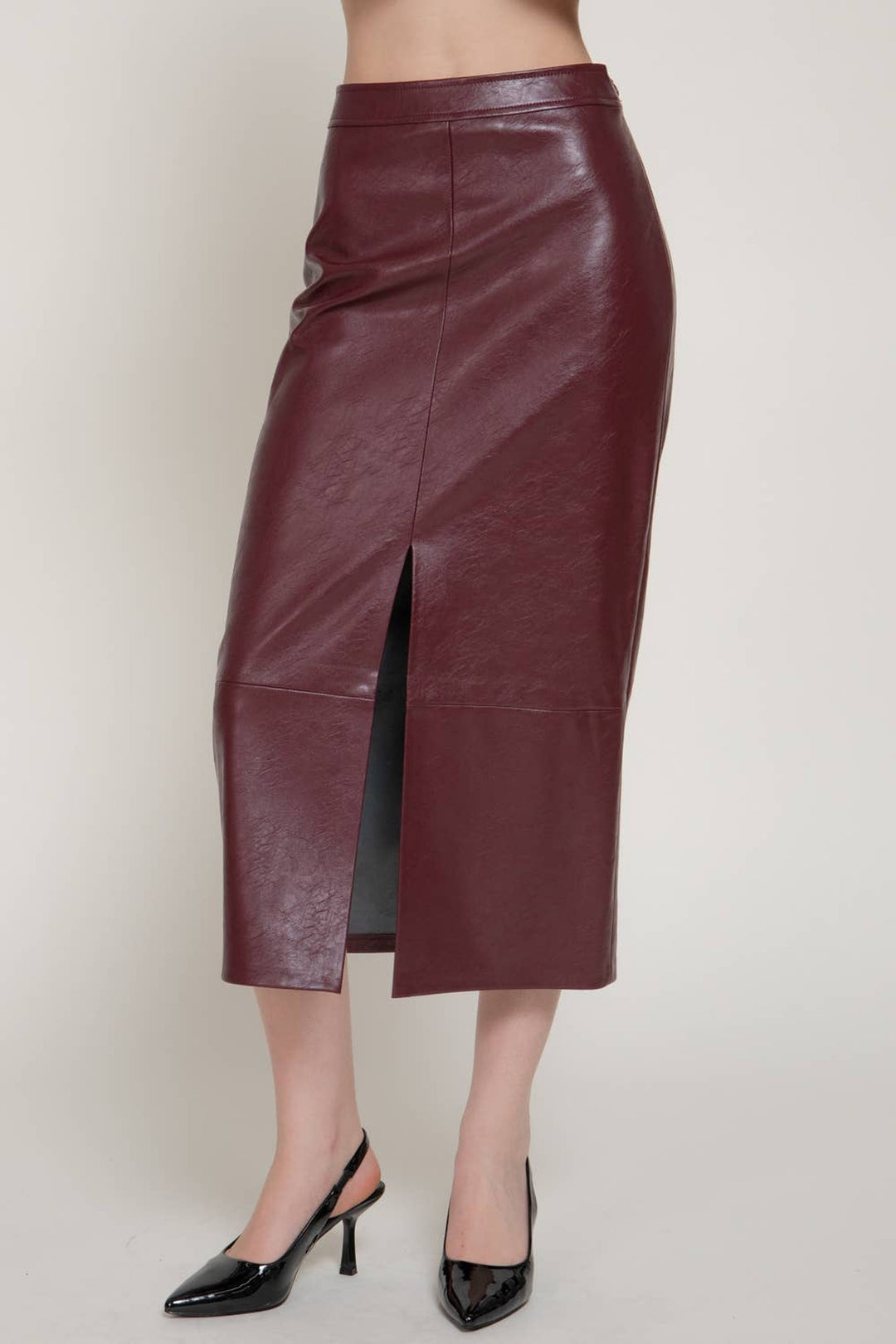 Front close view of the ember wine faux leather midi skirt showing the front slit, a Christmas party skirt