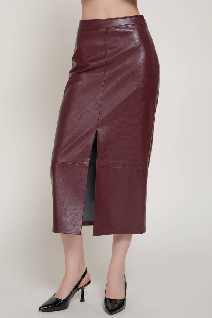 Front close view of the ember wine faux leather midi skirt showing the front slit, a Christmas party skirt