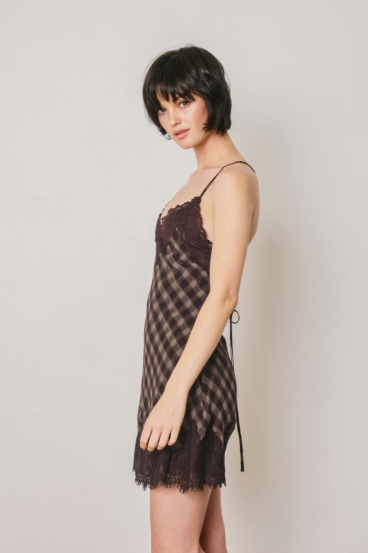 Side view of the espresso checkered slip mini dress with scalloped lace hem