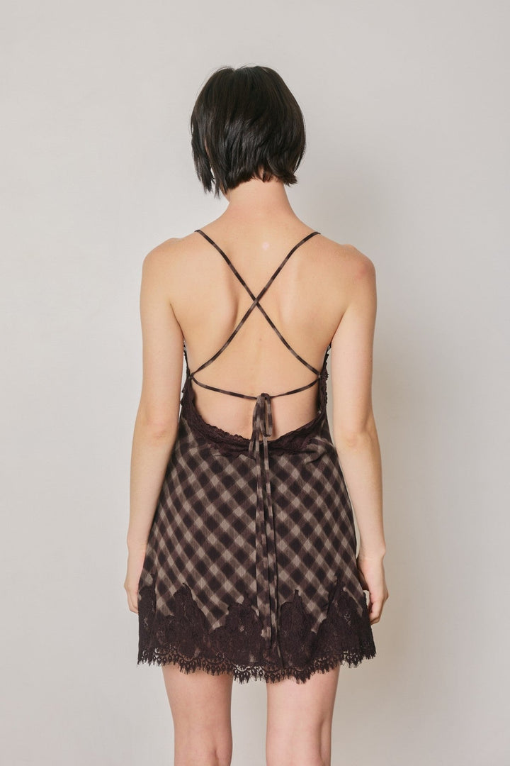 Back view of the espresso checkered slip dress with crossed straps and back tie, open back