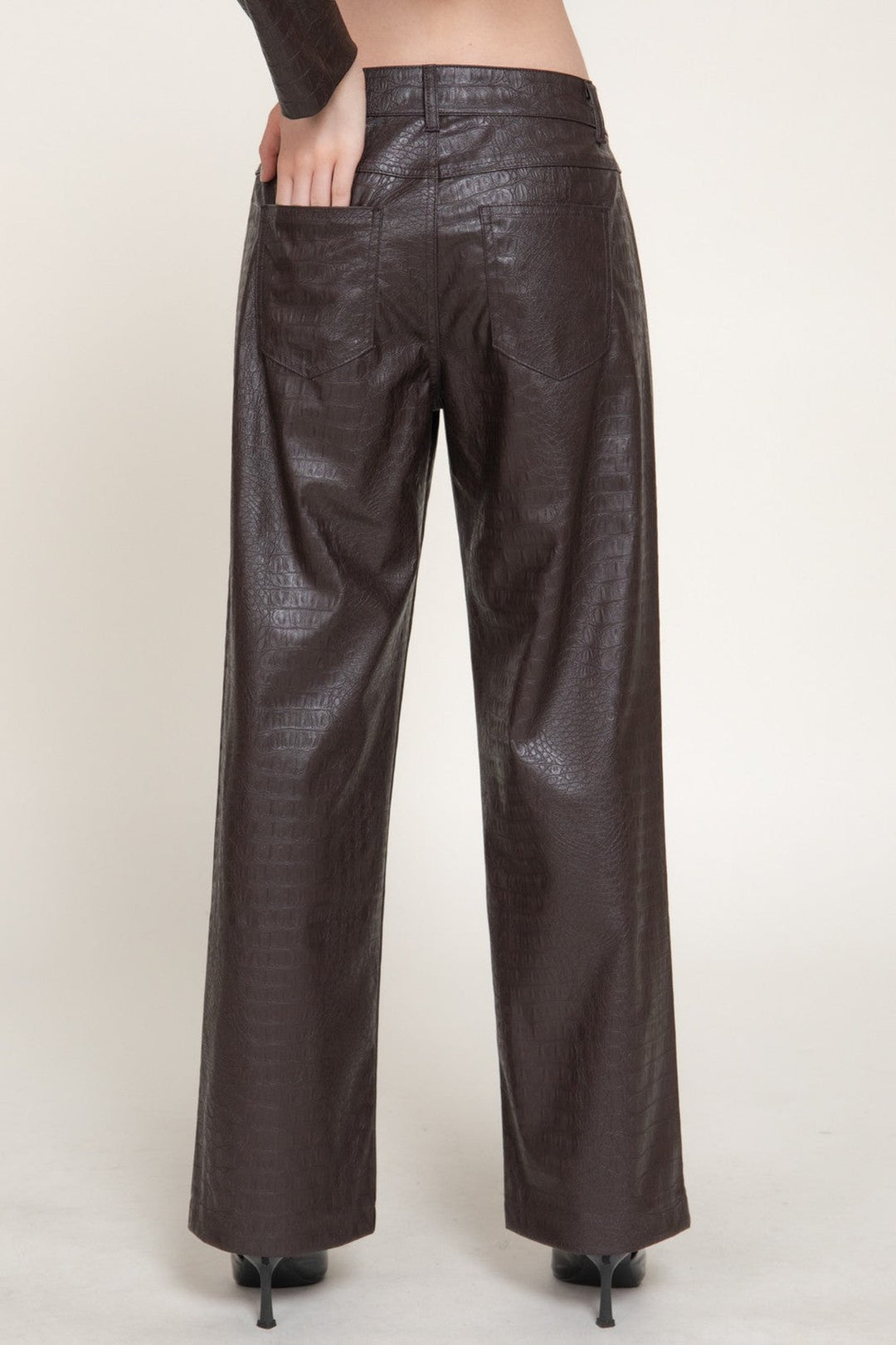 Back view of the espresso brown croc embossed faux leather pants with back pockets