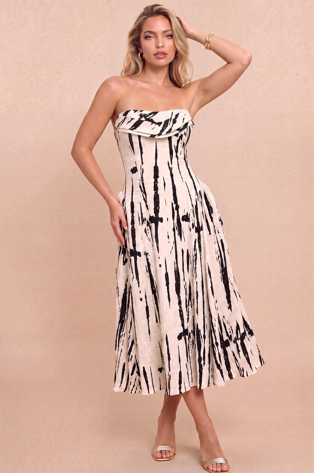 Front view of Luxxel taupe and black strapless midi dress with a folded neckline and abstract brushstroke print