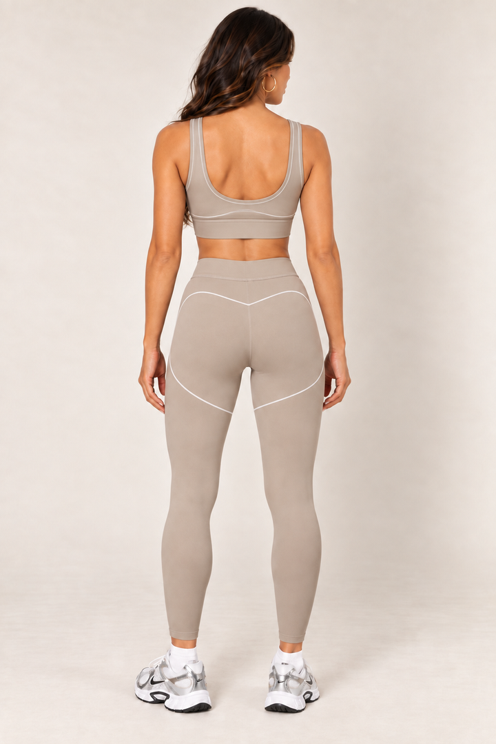 Taupe sports bra styled with matching leggings — full back