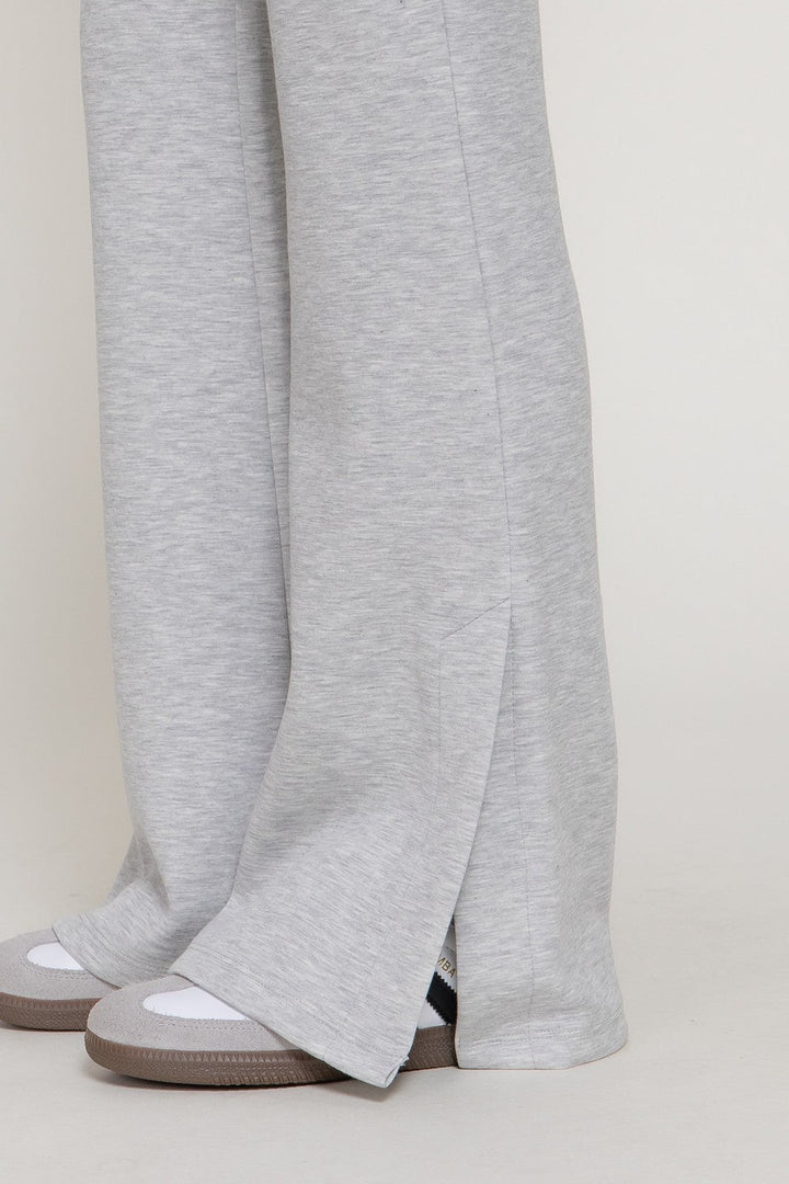 Close up of the slit hem on the heather grey flare pants