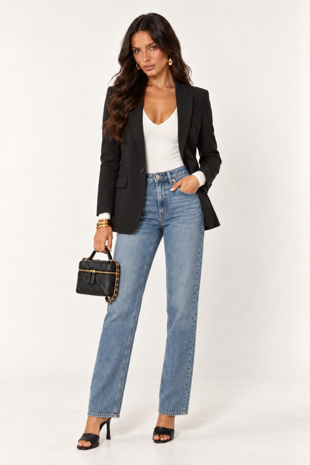 Love Poem black one-button boyfriend blazer, styled with blue jeans, a white V-neck bodysuit, black mules and quilted handbag.