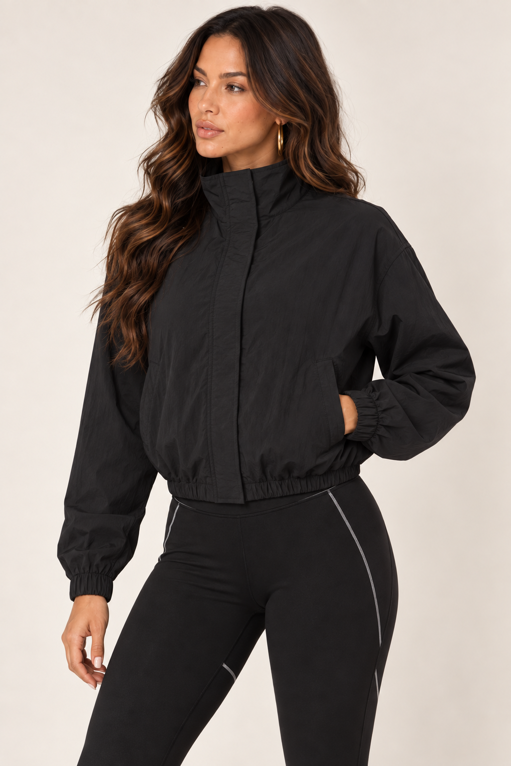 Black cropped windbreaker — thigh up left zipped