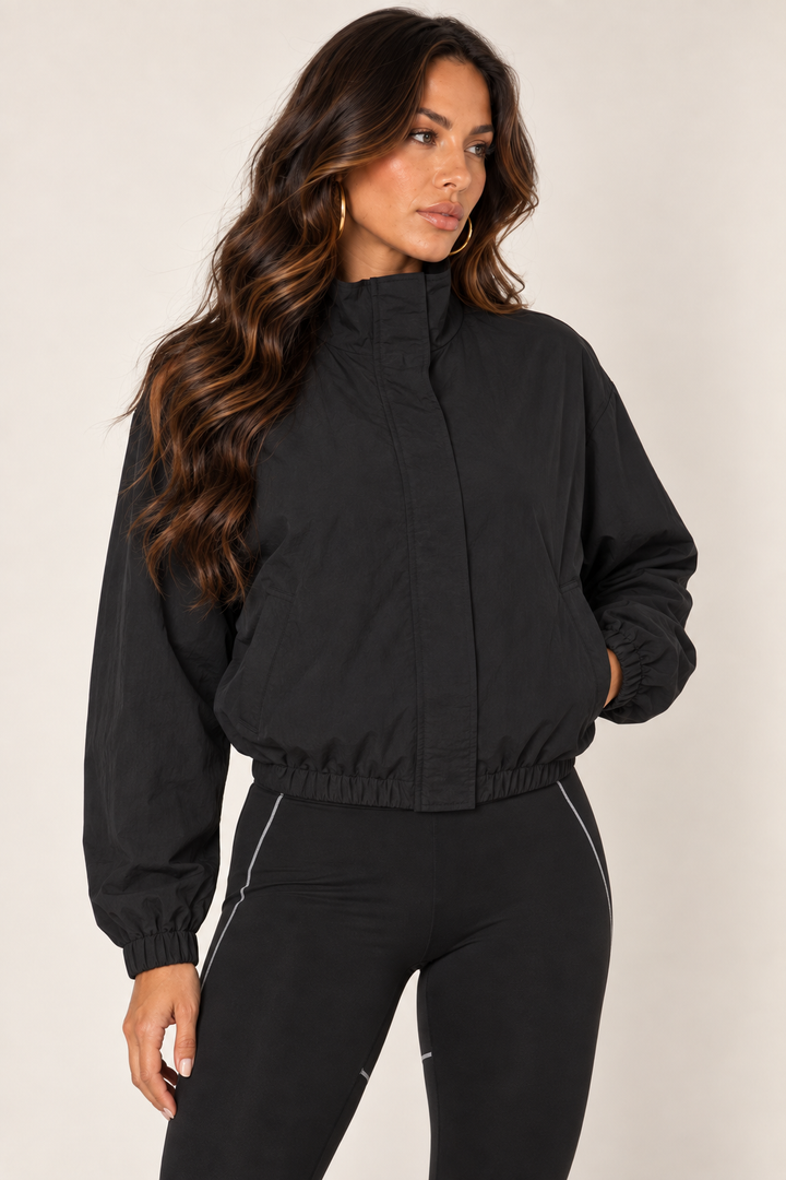 Black cropped windbreaker — thigh up right zipped
