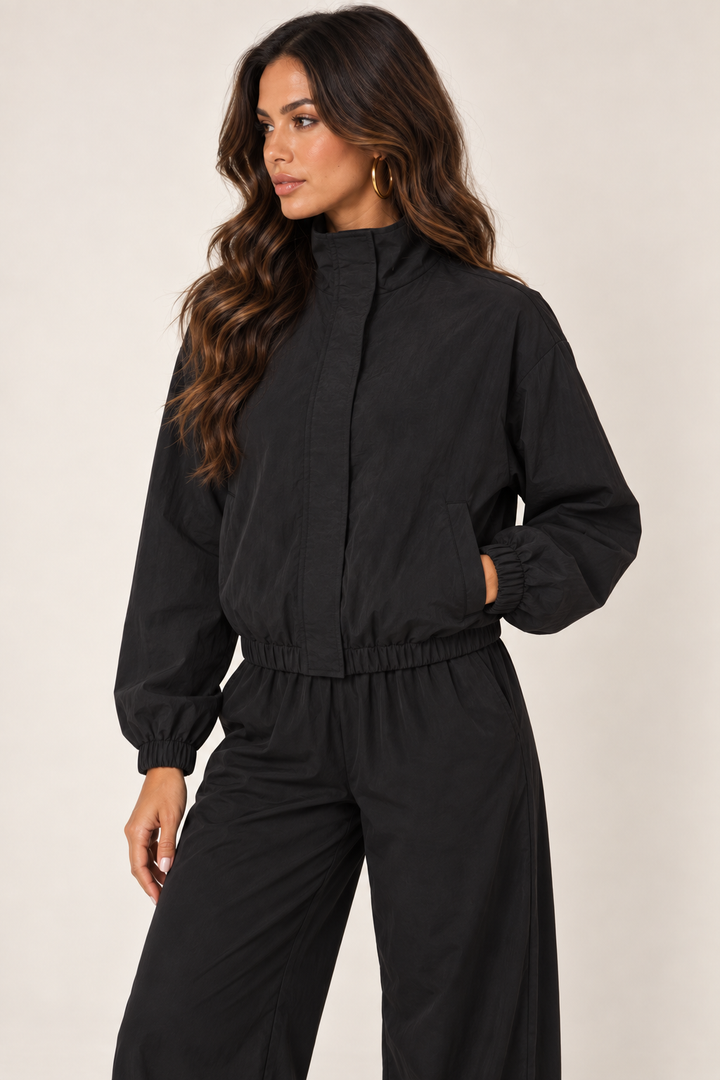 Black cropped windbreaker — thigh up left zipped