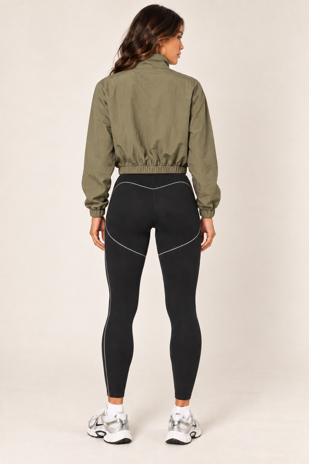 Olive cropped windbreaker with black leggings — full back