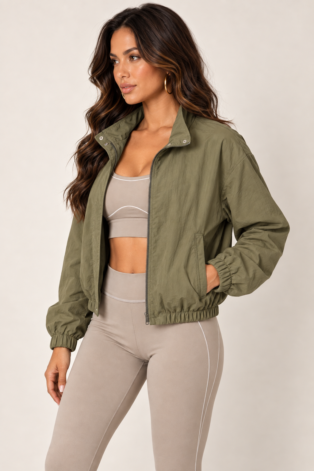 Olive cropped windbreaker with taupe leggings — thigh up left open