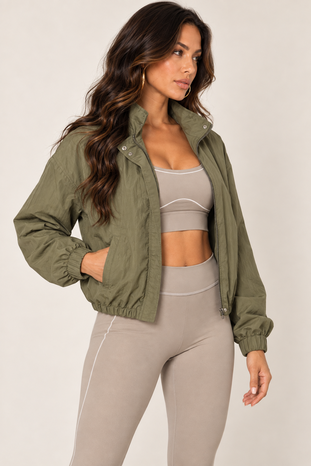 Olive cropped windbreaker with taupe leggings — thigh up right open