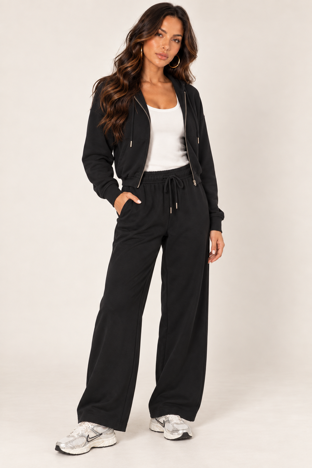 Black LOVE TREE cropped zip hoodie and wide-leg sweatpants — Left outfit · white ribbed tank
