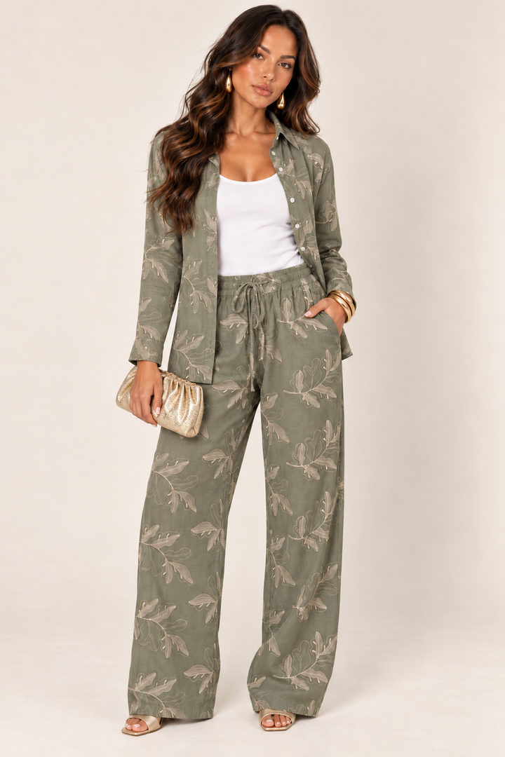 ALX hair-down model wearing olive embroidered pant set styled with the gold ruched clutch