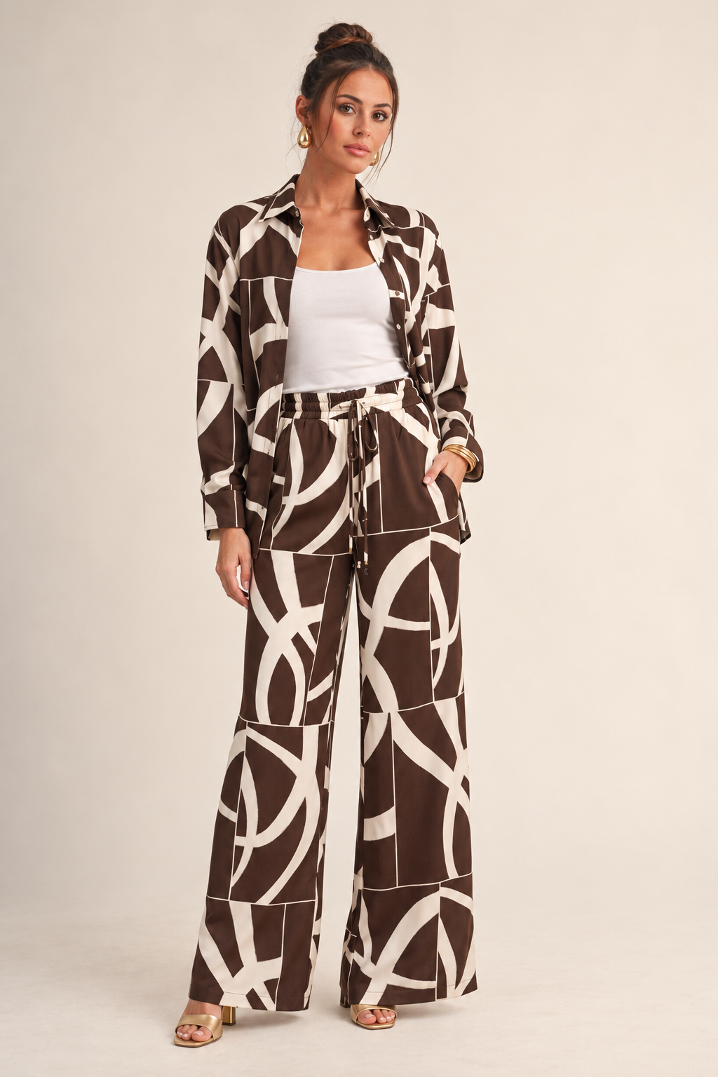 ALX model wearing Luxxel ivory brown two-tone abstract pant set with gold accessories