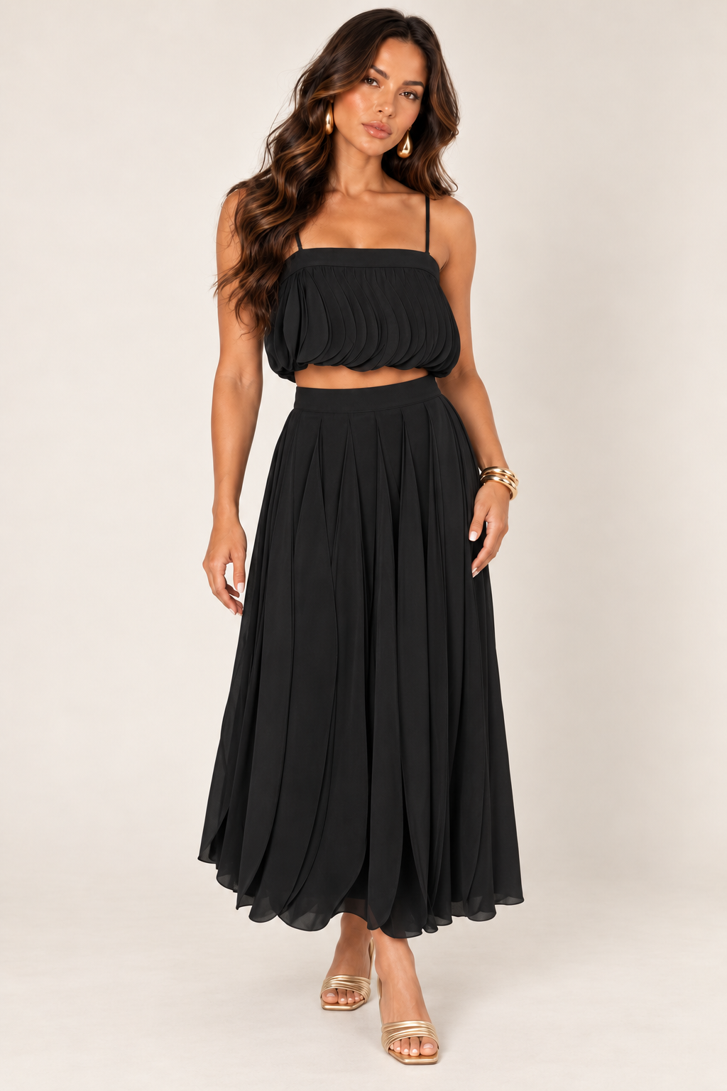 ALX model wearing Luxxel black petal layer skirt set with gold accessories
