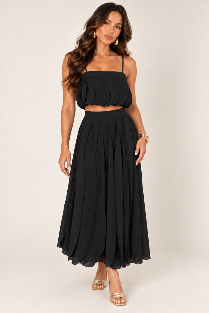 ALX model wearing Luxxel black petal layer skirt set with gold accessories