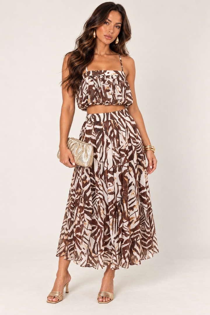 ALX hair-down model wearing brown ivory petal layer skirt set styled with the gold ruched clutch
