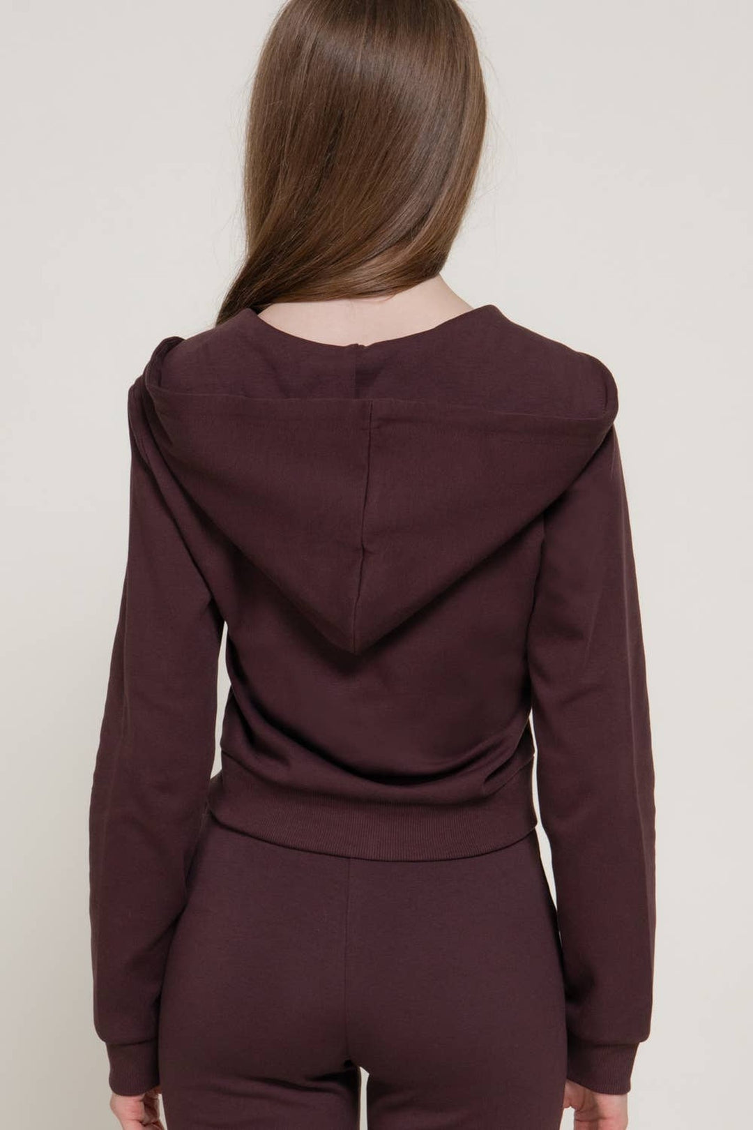 Back view of the maroon hoodie knit jacket showing the hood and ribbed hem