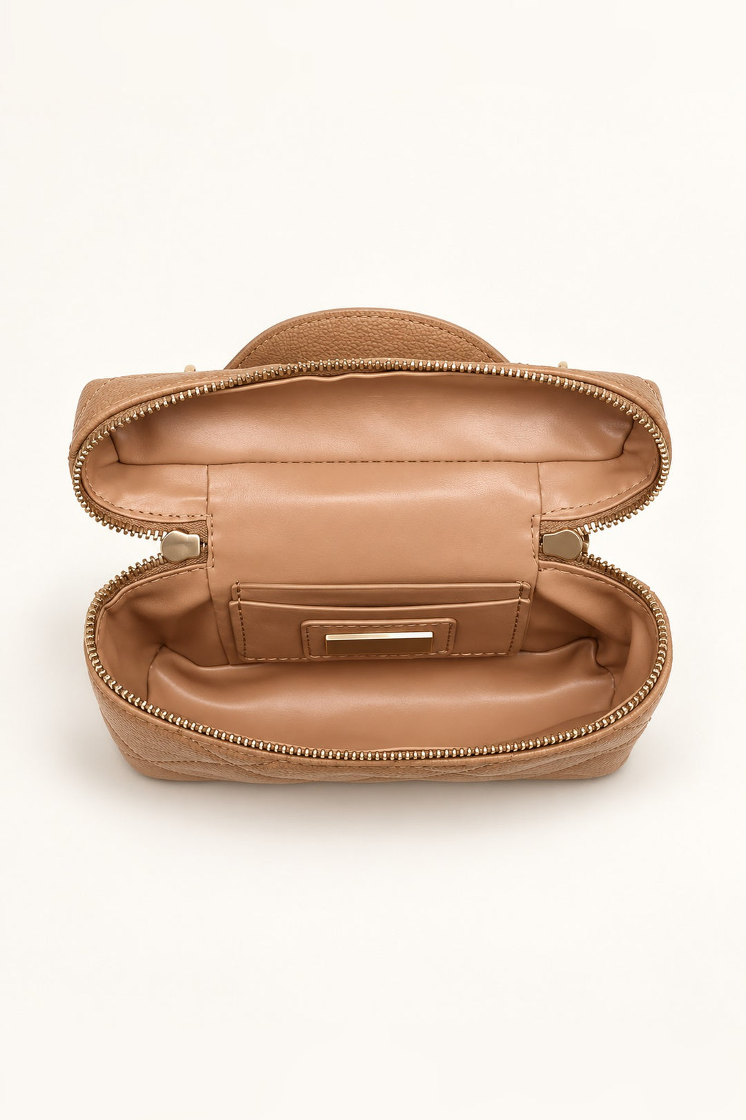 Open interior of the tan quilted crossbody showing lined compartment with card and slip pockets