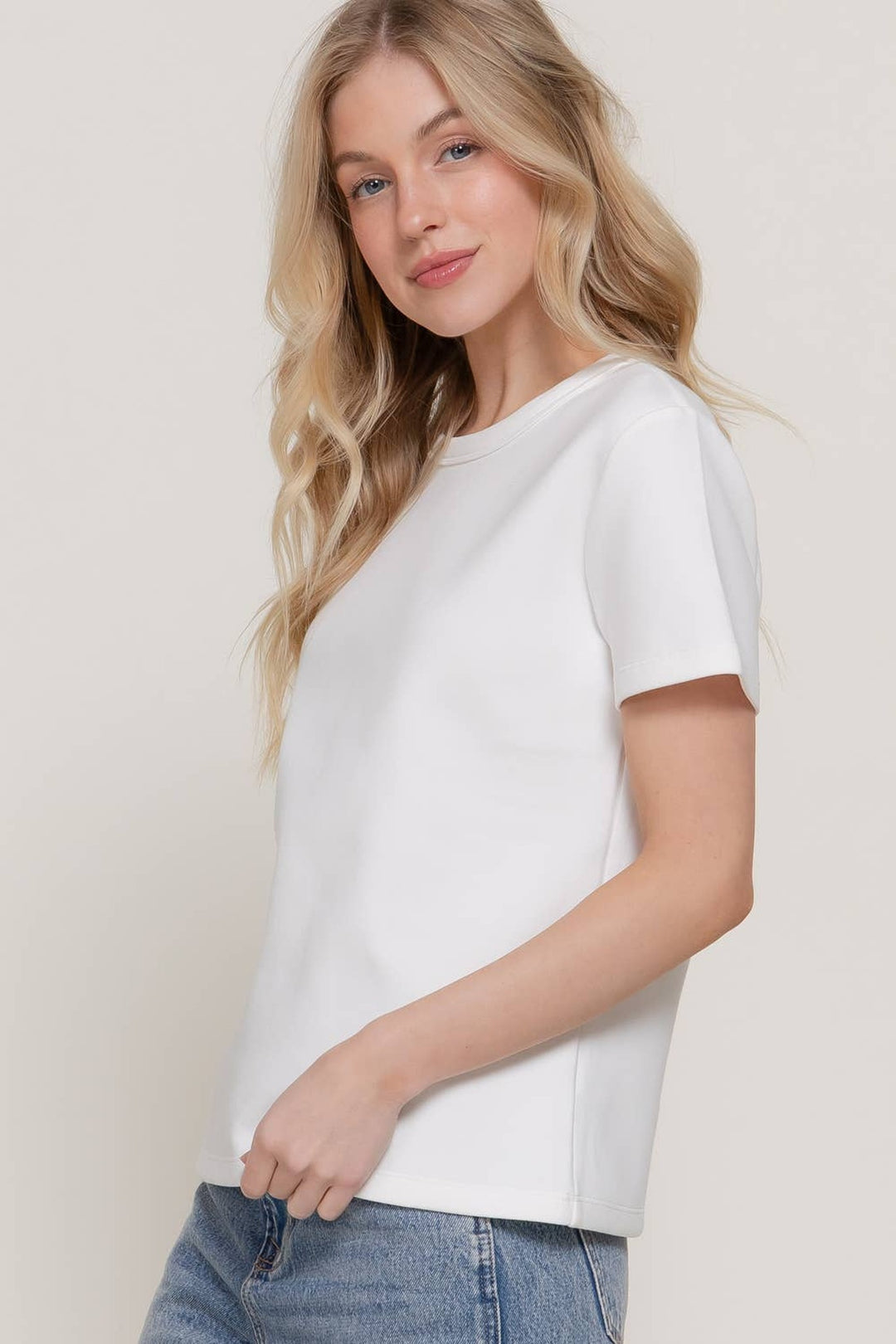 Front view of the off white short sleeve round neck soft knit jersey tee