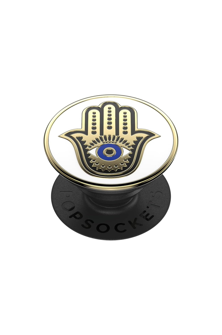 A PopSocket phone grip featuring a gold and black Hamsa hand with a blue and white eye design on the top, mounted on a black circular base with &