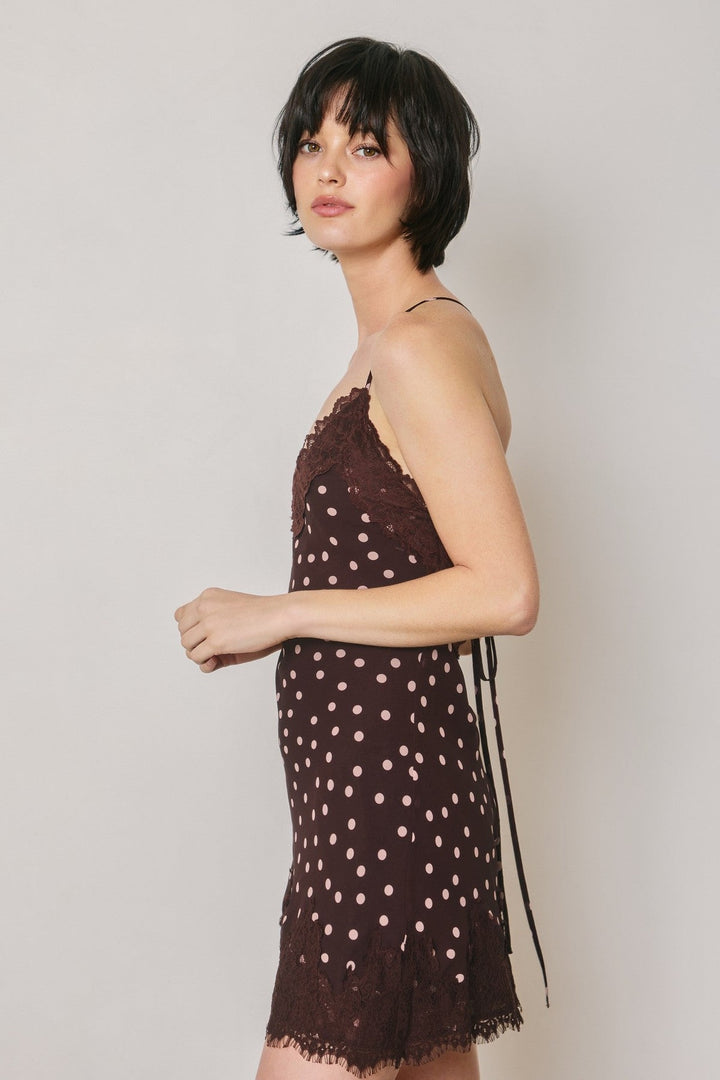 Side view of the plum polka dot chiffon slip mini dress with lace hem