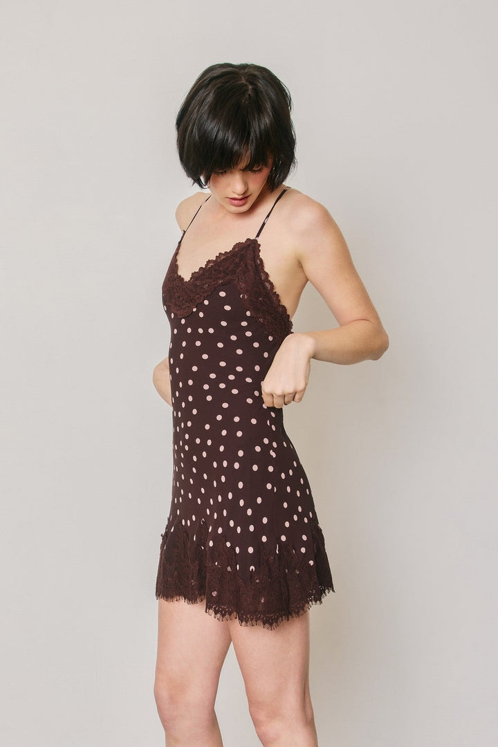 Plum polka dot slip mini dress showing the lace trim hem and lightweight chiffon