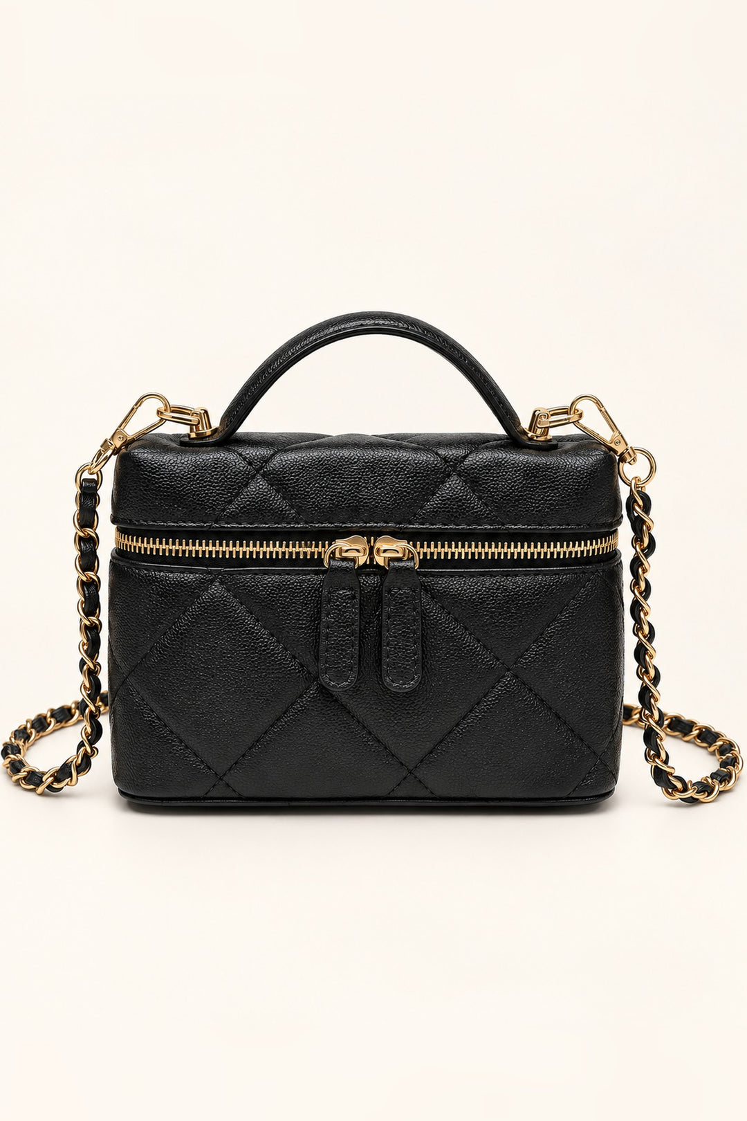 Front view of the Black Snow Quilted Crossbody in vegan leather with gold chain strap and top handle