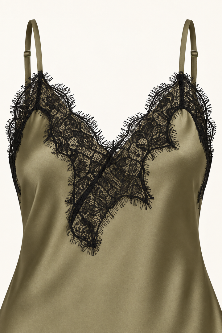 Product-only neckline detail of the Khaki Satin Lace Pants Set by Skylar Rose at Styled by ALX. Thin olive straps meet an asymmetric V neckline edged in black floral eyelash lace, with a diagonal lace applique extending over the smooth olive-khaki satin camisole front.