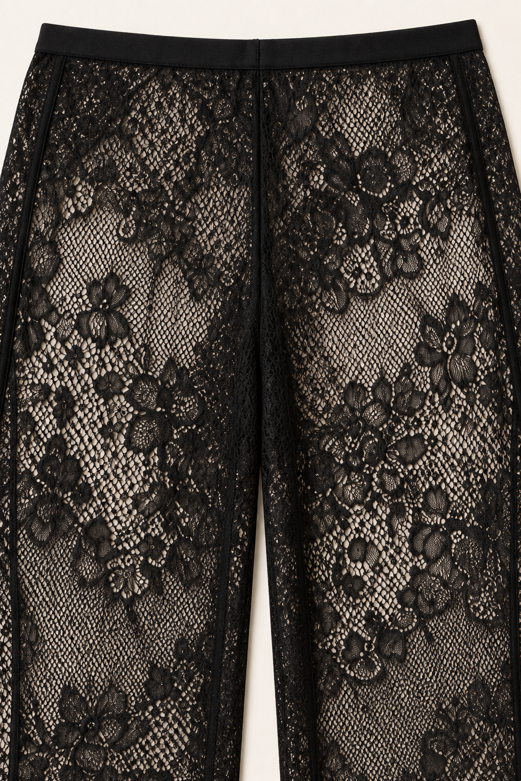 Product-only trouser detail from the Khaki Satin Lace Pants Set by Skylar Rose at Styled by ALX. The close view shows the black floral lace pattern and waistband construction of the wide-leg pants, with fine mesh and raised floral motifs displayed against a pale studio background.