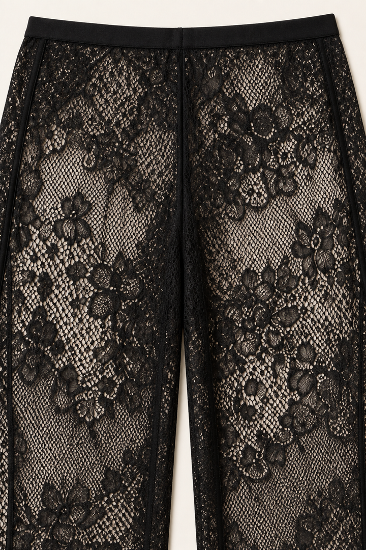 Product-only trouser detail from the Khaki Satin Lace Pants Set by Skylar Rose at Styled by ALX. The close view shows the black floral lace pattern and waistband construction of the wide-leg pants, with fine mesh and raised floral motifs displayed against a pale studio background.