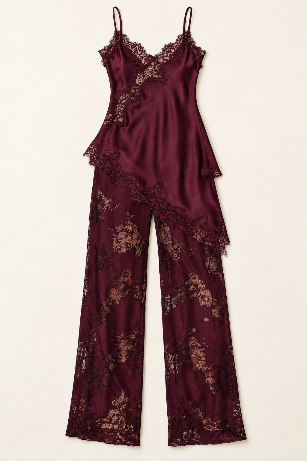 Product-only front view of the Burgundy Satin Lace Pants Set at Styled by ALX, with the long satin camisole arranged over matching wide-leg lace trousers. The deep wine set features thin straps, a diagonal floral lace neckline inset and an irregular lace-edged tunic hem against ivory.