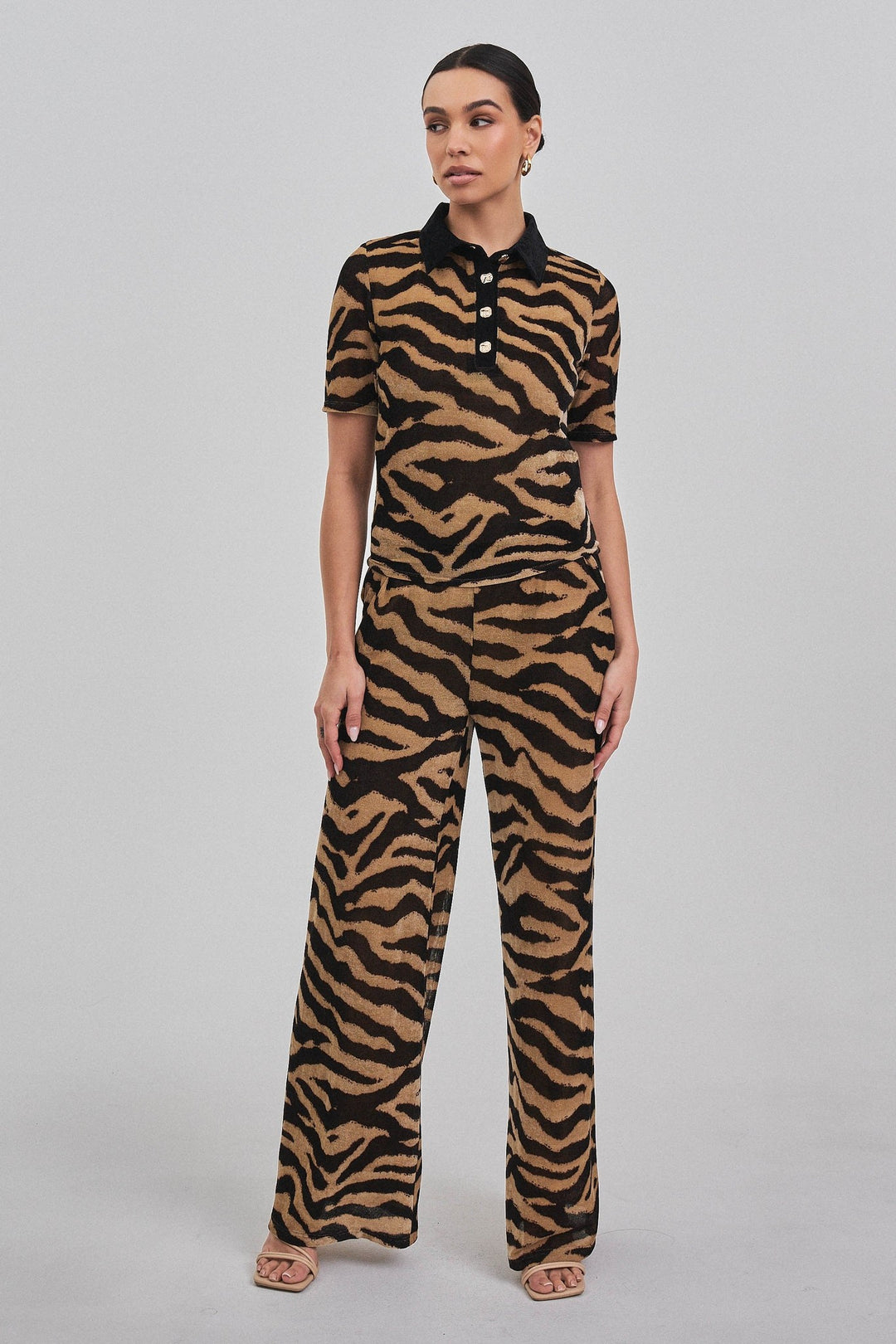 Taupe black zebra print polo top, side view