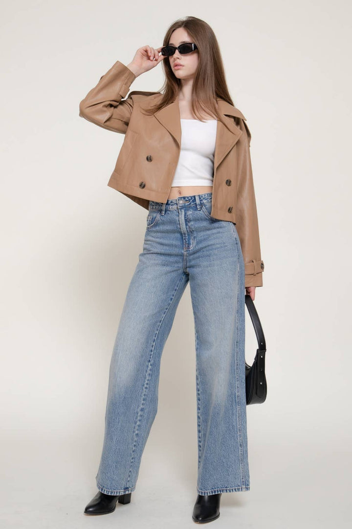Full-length view of the Toffee Faux Leather Short Trench Coat with light-wash jeans and black boots, a fall outfit