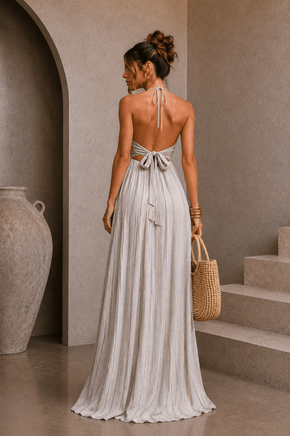 Open back with a wide self-tie bow on a pinstripe maxi dress
