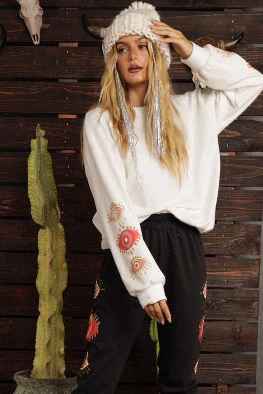 Evil eye print sweater styled as part of a lounge set